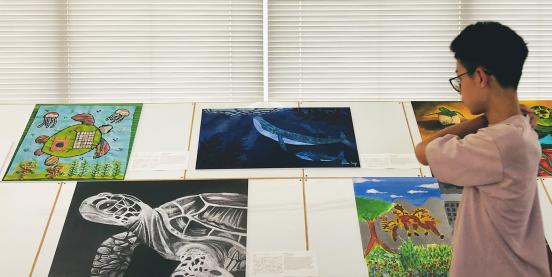 A visitor looks at artwork at the Art Challenge Exhibition 2023